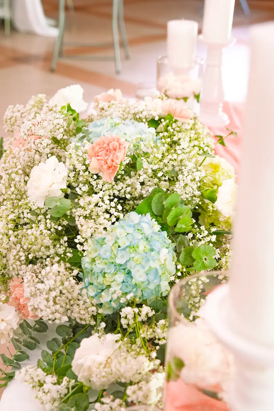 A pastel wedding bouquet with hydrangeas, carnations and baby’s breath