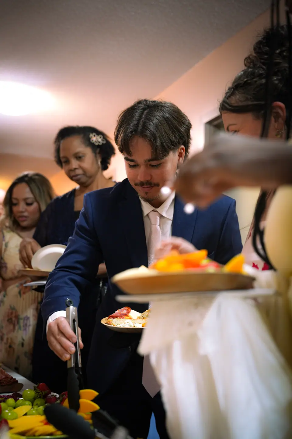 The newlyweds serving dinner together at their reception