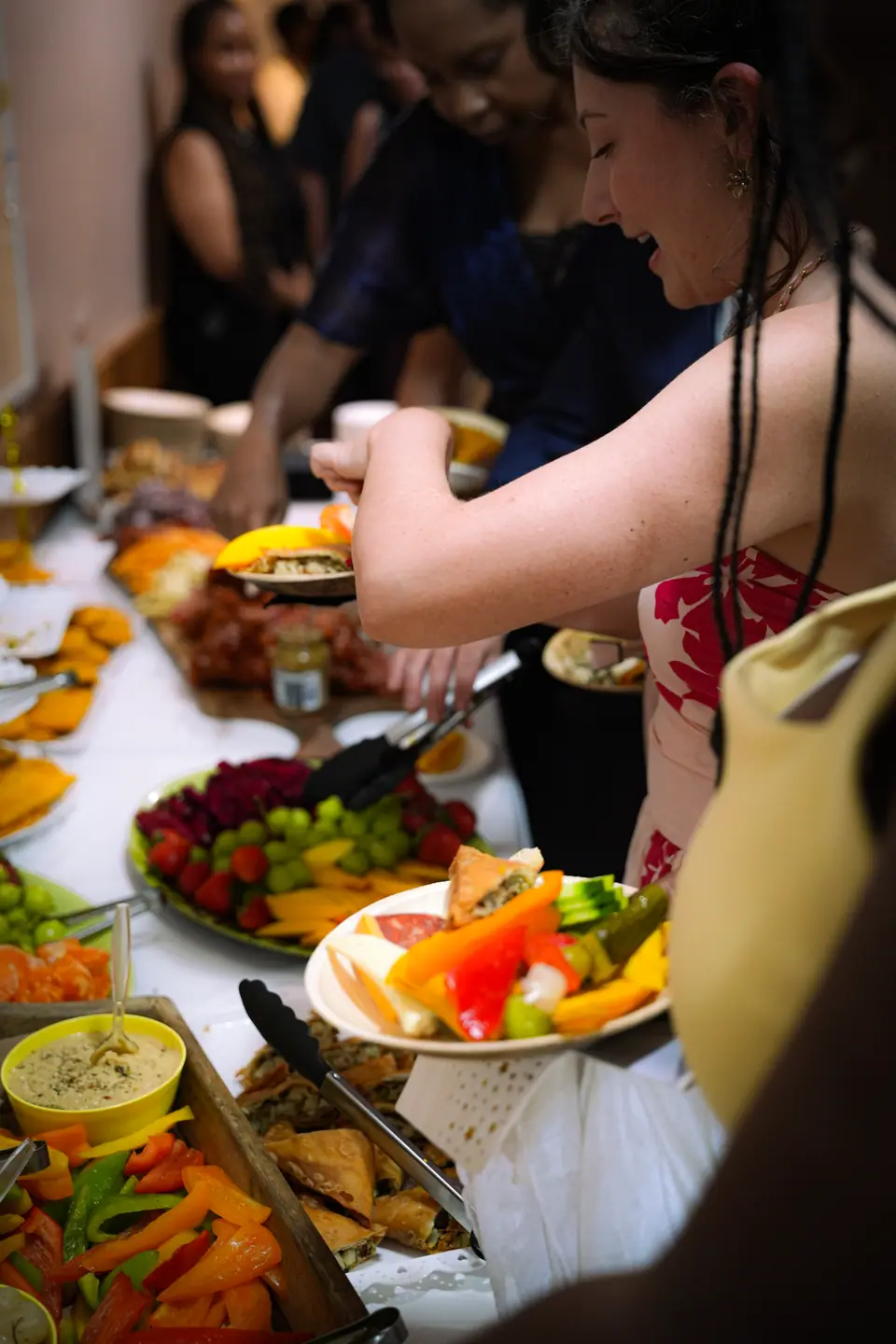 Guests sharing food around a colourful reception table