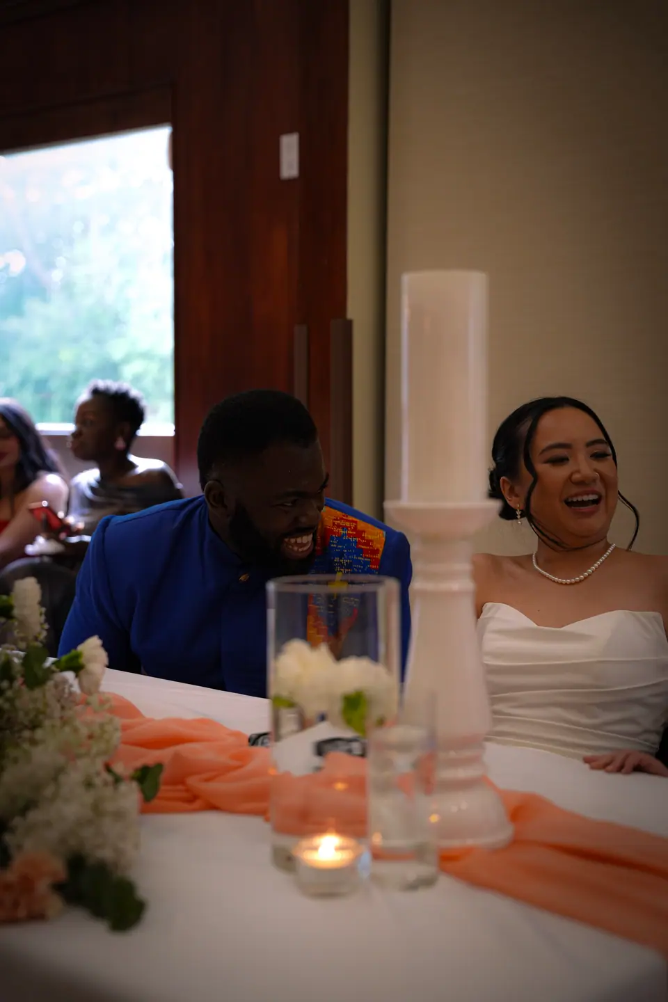 The couple laughing together during the reception