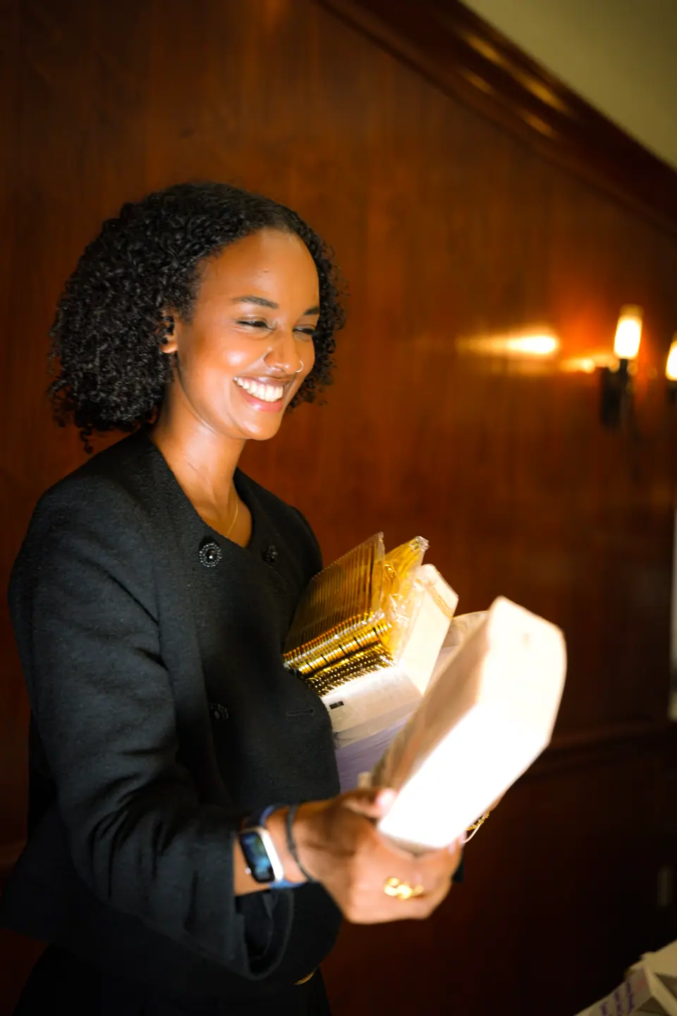 A guest smiling during an evening wedding toast