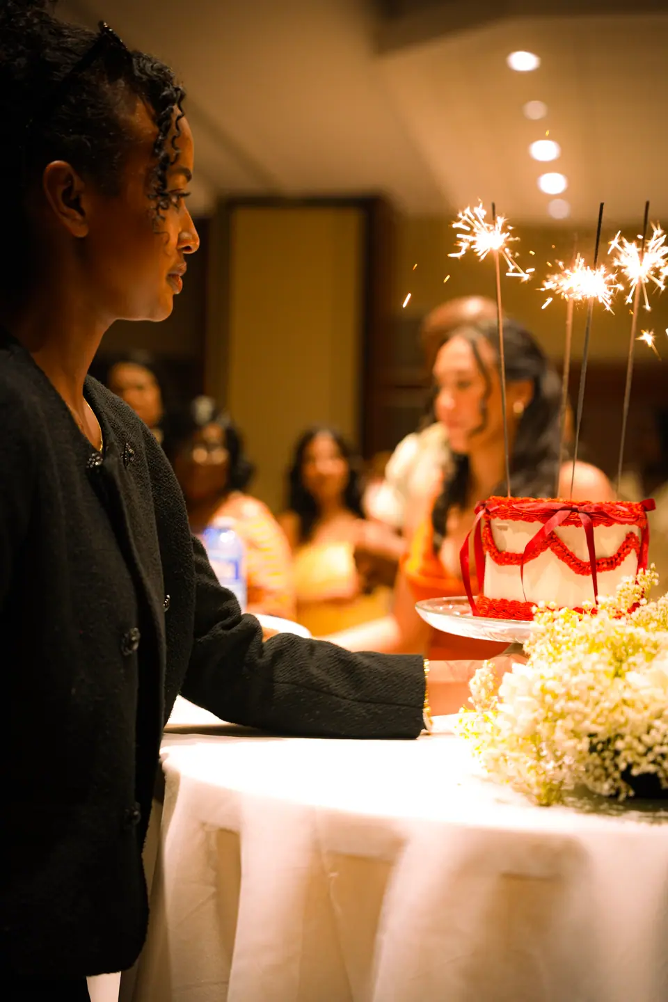 A guest lighting sparklers beside the dessert table