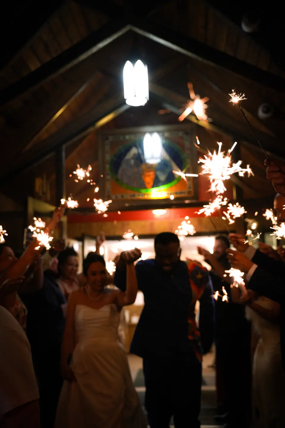 A room of guests celebrating with sparklers