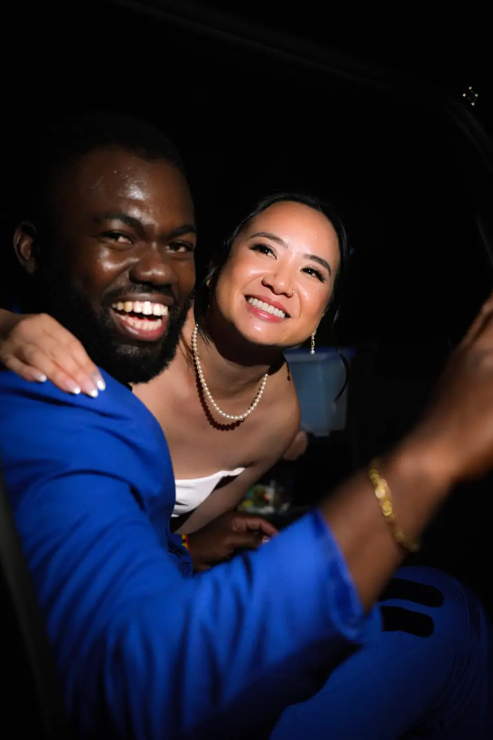 Two wedding guests smiling together at the end of the night